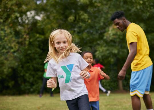 Kids running in a YMCA play field