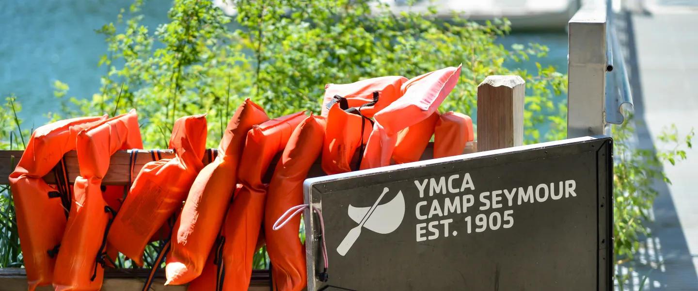 Life jackets hanging on a fence