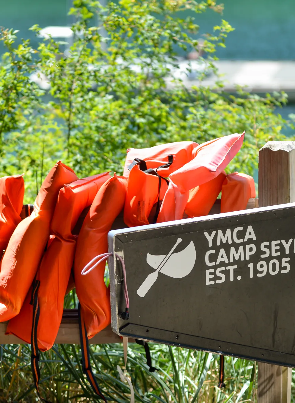 Life jackets hanging on a fence