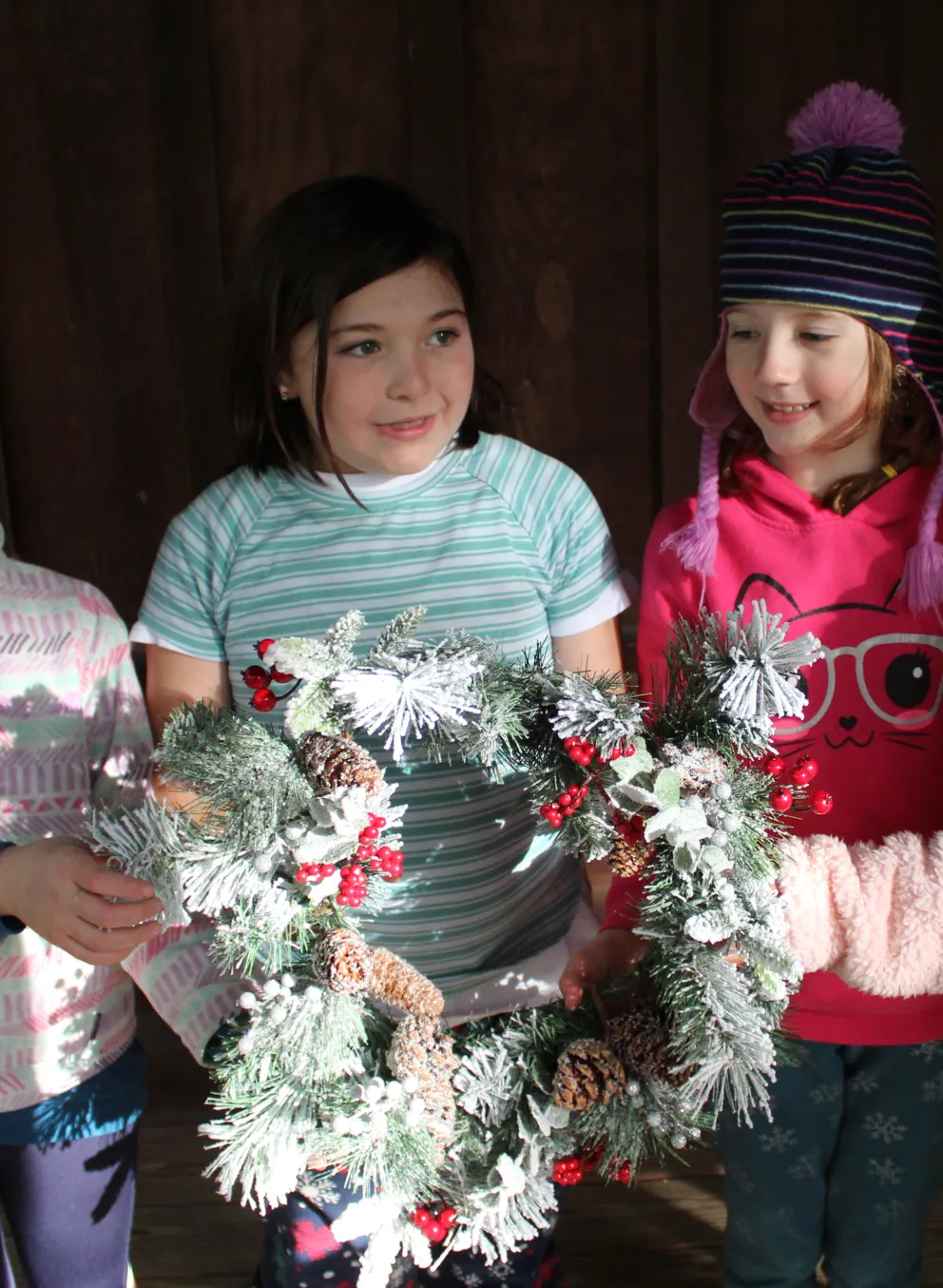 Group of campers holding a wreath
