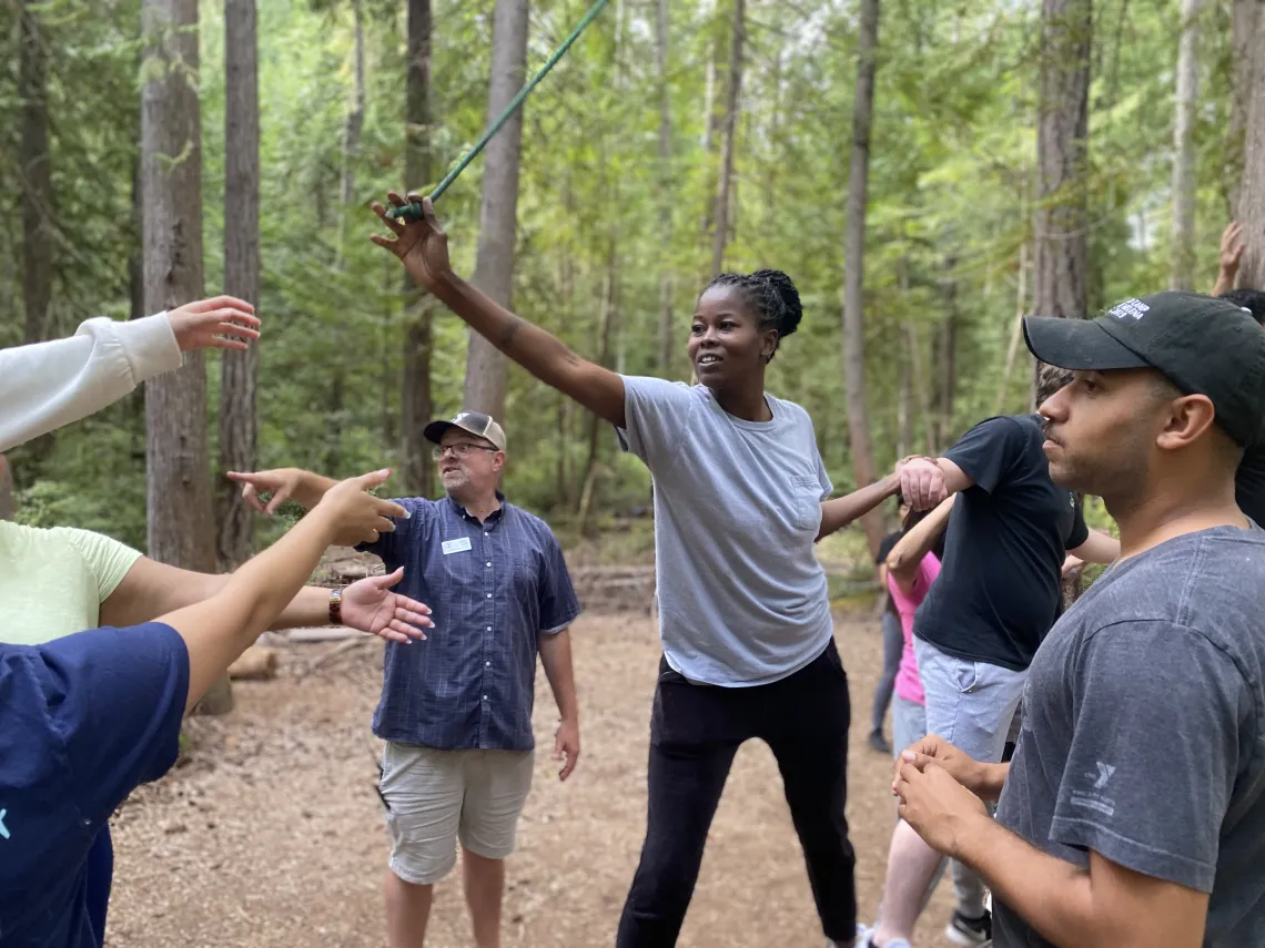A group of adults on low ropes element