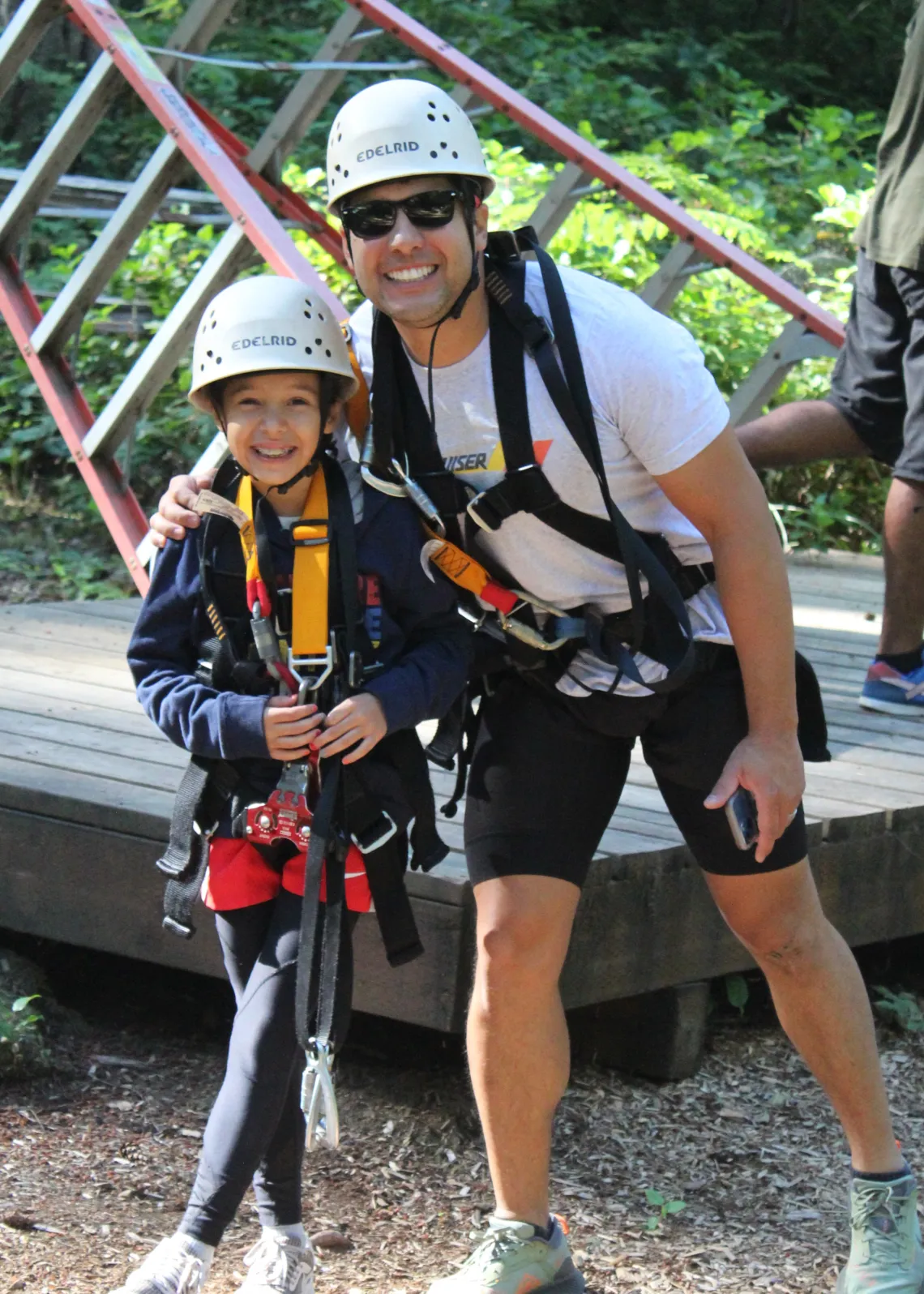 Two people in helmets and harnesses 