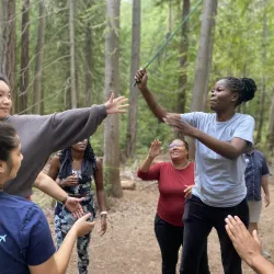 Group of adult participating in low ropes activities