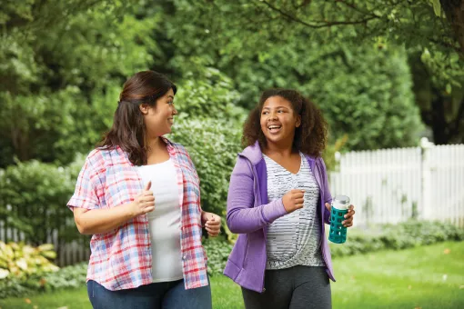 Mother and Daughter Walking Together With YMCA Weight Loss Program