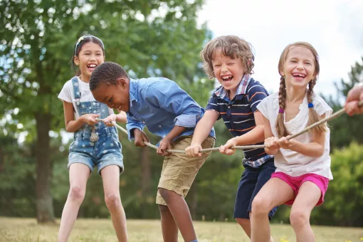 Kids Playing Tug Of War At YMCA Summer Day Camp