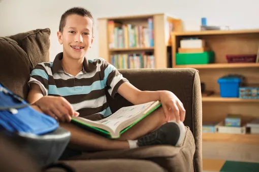 Teen reading on couch