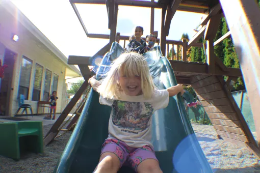 Children in the full-time preschool playing on the playground at the UP ELC 