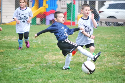 Youth soccer player making a kick