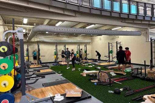 YMCA staff work to set up a renovated work out area