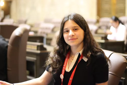 youth and government student poses in the Washington State Capitol during a hearing.