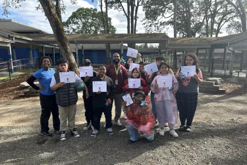 CLC students pose with their academic achievement certificates at the YMCA