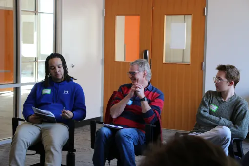3 people chat at a social event at the YMCA