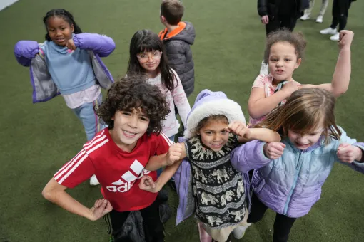 Campers pose for a picture on the covered turf at the YMCA