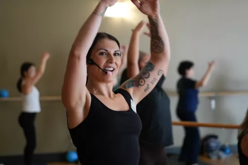 Action shot of a barre instructor mid lesson at the YMCA