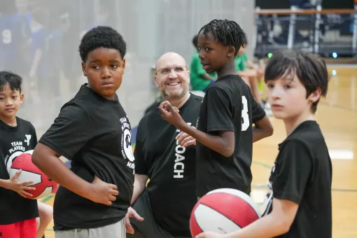 Shot of a team huddle with the coach during a basketball tournament at the YMCA