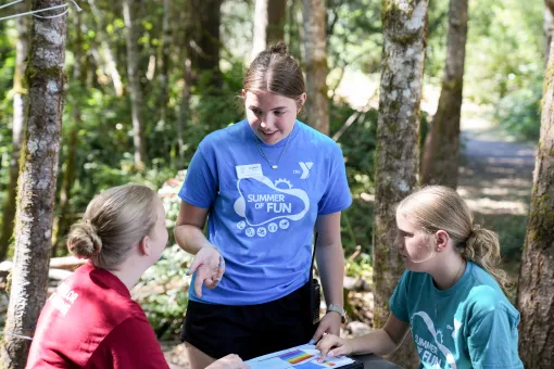Three camp sisters talk at a table