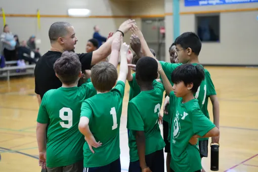 Youth Sports League team on the basketball court highfiving