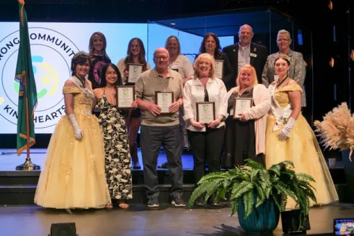 Stef and her cohort with their awards on stage