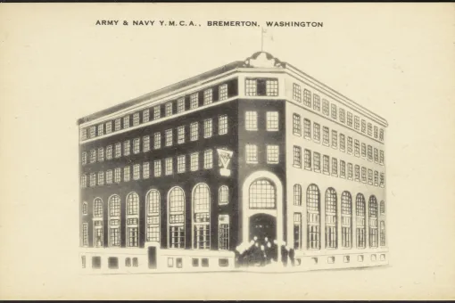 Alt text:  Historic postcard illustration of the Army & Navy YMCA building in Bremerton, Washington, showing a four-story brick structure with large arched windows and the YMCA emblem near the main entrance.