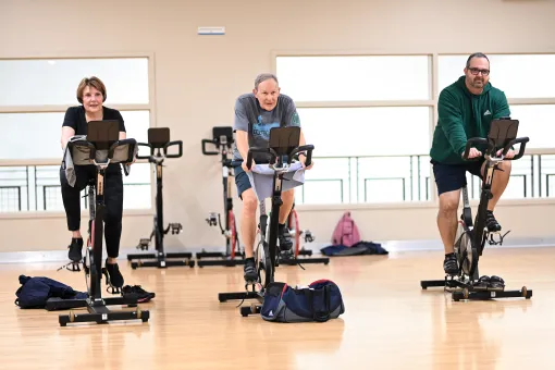 Three Active Older Adults in YMCA Cycling Class