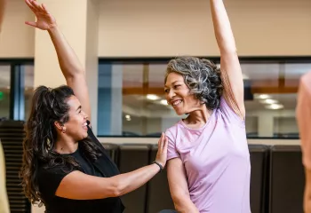 Active Older Adult Stretching In YMCA Group Exercise Class