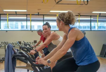Smiling In Group Exercise Cycling Class