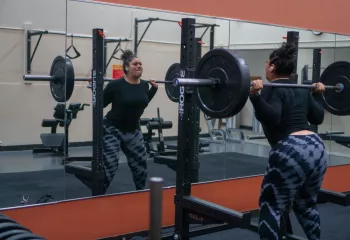 Squat In Mirror At YMCA Training Center