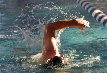 Man Swimming Laps At YMCA Pool
