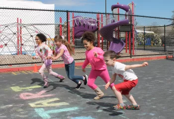 Action shot of Healthy Kids Day participants starting to run the fun run at the YMCA