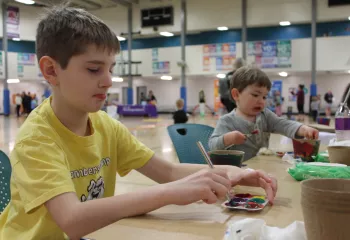 Healthy Kids day participants paint biodegradable planters at the YMCA