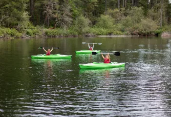 Kayakers pose for a picture in the middle of Lake Helena at YMCA camp