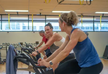 Action shot of an indoor cycling class held at the Tacoma Center YMCA