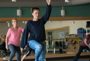 Action shot of a PiYo (Pilates and Yoga) session at the Gordon Family YMCA