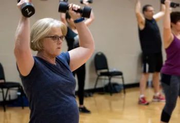 Action shot of a dumbell class session at the Mel Korum Family YMCA
