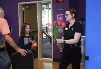 YMCA staff hands out daffodils in spring at the YMCA