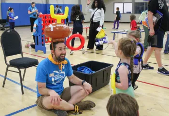 Action shot of a fun ring toss game during Healthy Kids Day at the YMCA