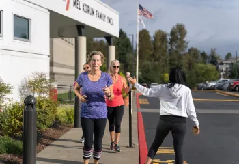 Action shot of bootcamp participants running outside at the YMCA