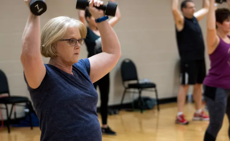 Action shot of a dumbell class session at the Mel Korum Family YMCA