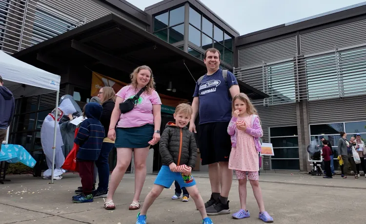 Family Poses outside during Healthy Kids Day at the YMCA
