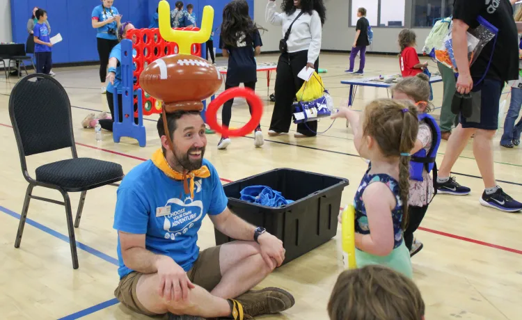 Action shot of a fun ring toss game during Healthy Kids Day at the YMCA