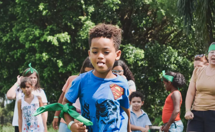 Image of youth running through play field