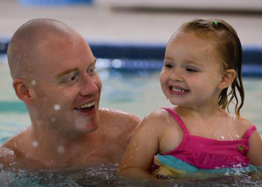 Father and daughter swimming