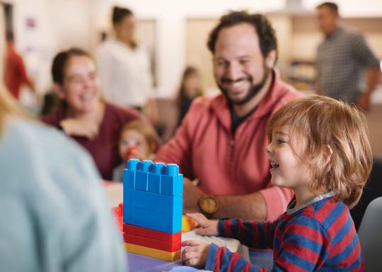 Father and child enjoying family night with building blocks