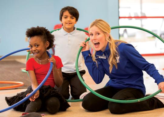 Two kids and an adult having fun with hula hoops