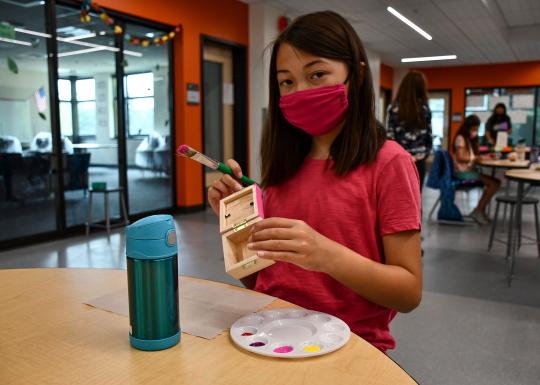 Girl Painting in YMCA Visual Arts Class