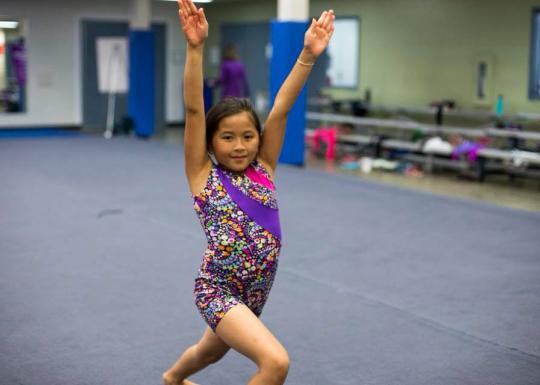 Girl Posing In YMCA Gymnastics Class