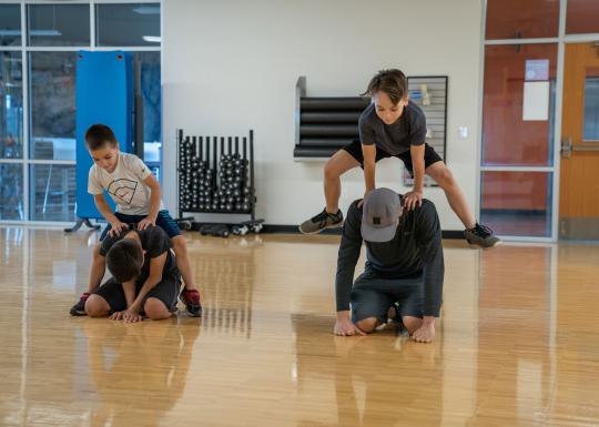 Tom Taylor Family YMCA Family Playing In Open Gym