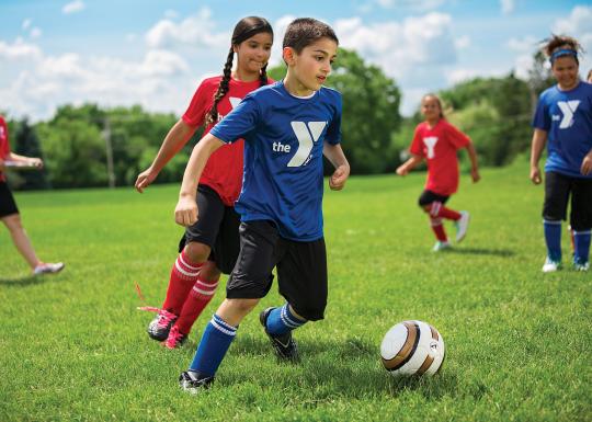 YMCA Youth Soccer Dribbling Down The Field