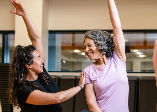 Active Older Adult Stretching In YMCA Group Exercise Class