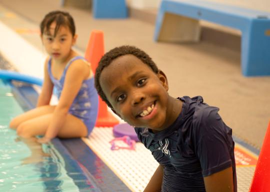 Smiling At The Pool Edge At YMCA Swim Lessons